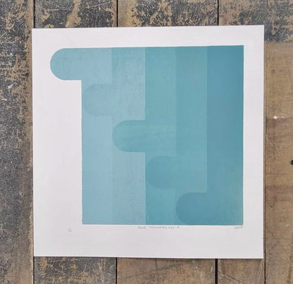 Set of 3 blue geometric screen prints on white, hand-pulled by InkBird Print Studio, textured wood base, stepped rectangle design.