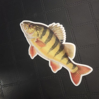 InkBird Print Studio vinyl die cut sticker of a bright yellow fish with black stripes, orange fins, on black textured background. Printed for Good Days Marina