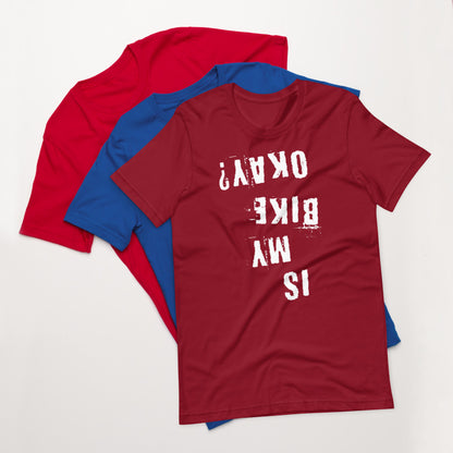 Three cotton t-shirts—red, blue, and maroon. Maroon shirt features distressed white upside-down “Is My Bike Okay?” cycling graphic.