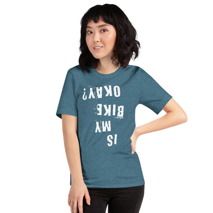 Woman models teal cotton tee with white upside-down text, Is My Bike Okay? Unique cyclist gift by InkBird Print Studio.