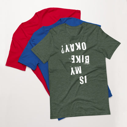 Green cotton Is My Bike Okay? mountain biking t-shirt by InkBird Print Studio, size medium, atop blue and red shirts.