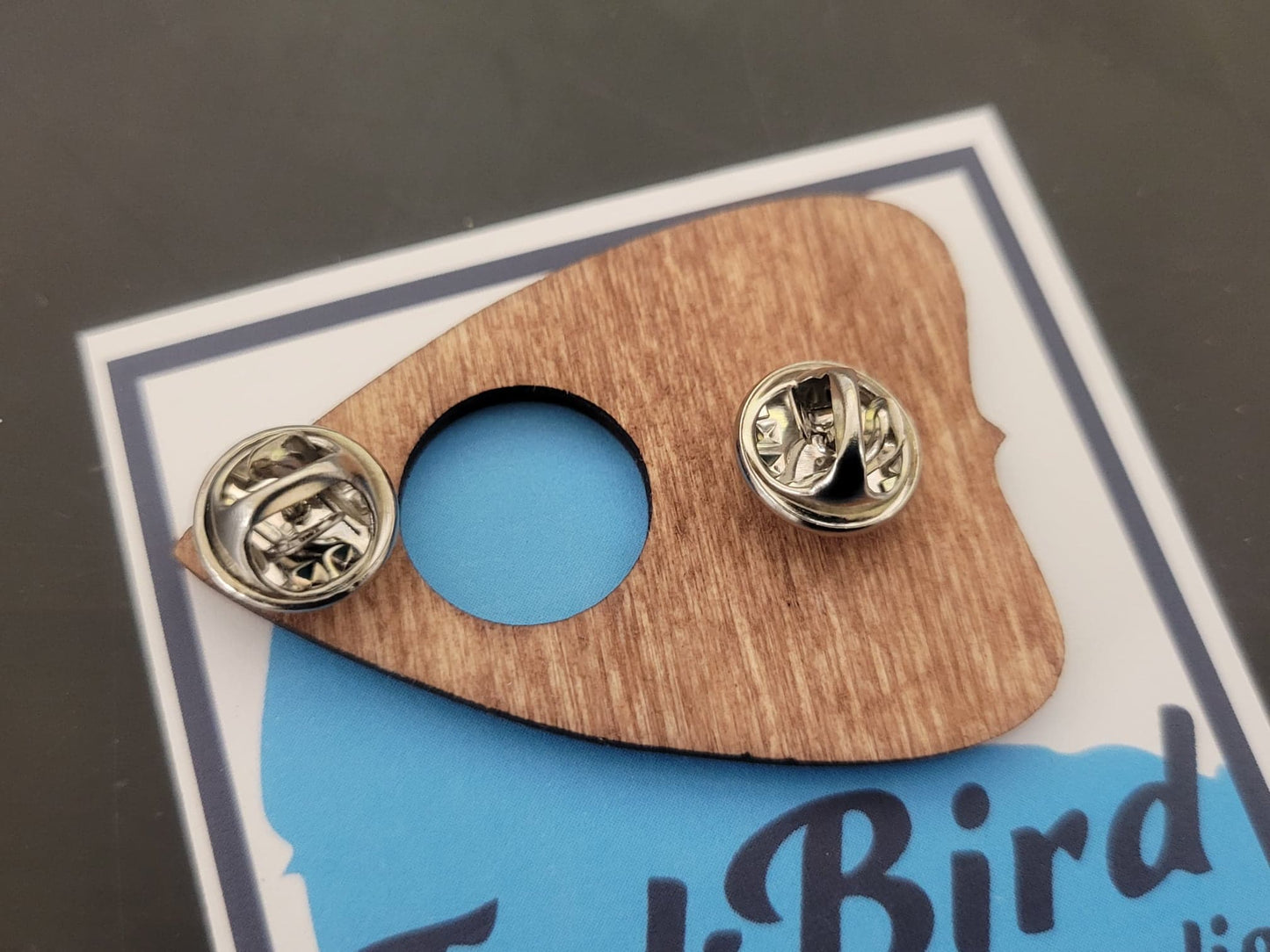 Laser-cut wooden planchette pin by InkBird Print Studio, natural wood color, large or small, dual metal backs on blue-logo display card.