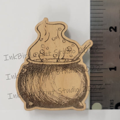 2-inch neodymium wood magnet with detailed, sketch-style cauldron and spoon engraving by InkBird Print Studio LLC.